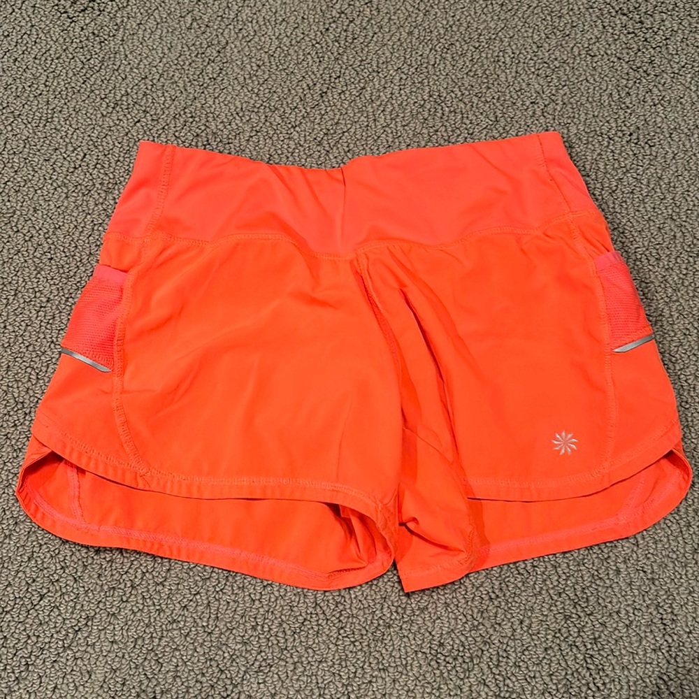 coral athletic shorts from athleta. barley worn